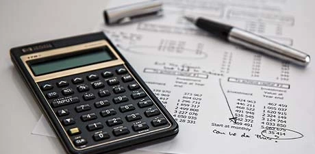Calculator and paperwork used for equipment valuations